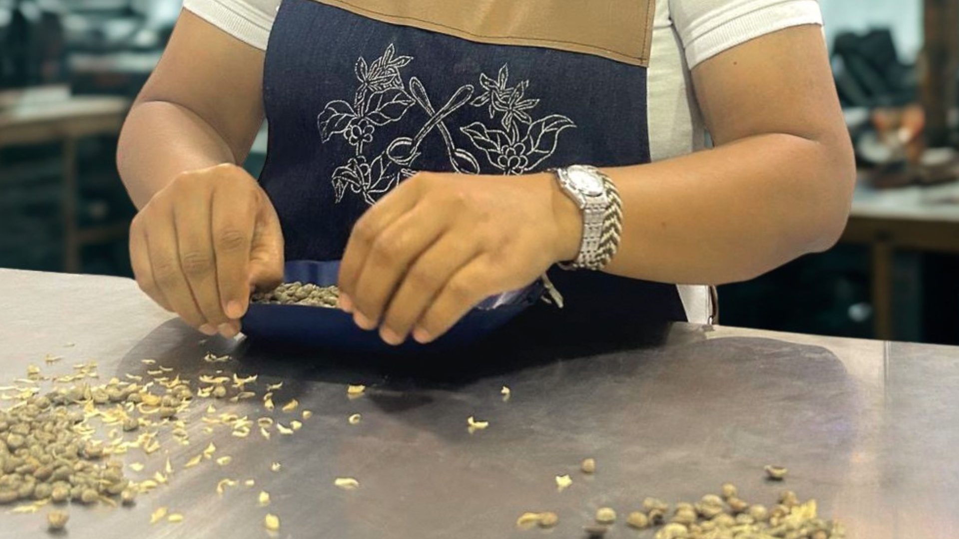 Woman sorting specialty coffee beans by hand in Colombia